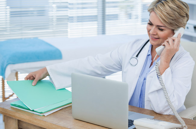Photo of doctor talking on phone at desk